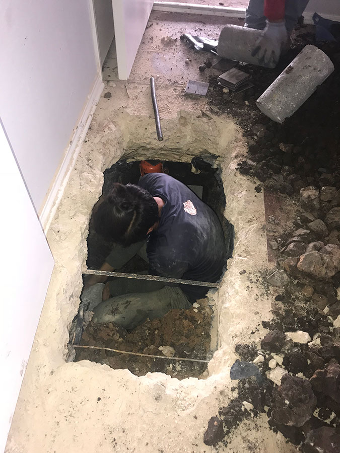 Professional from Pier Pressure Foundation Repair working on a foundation repair work